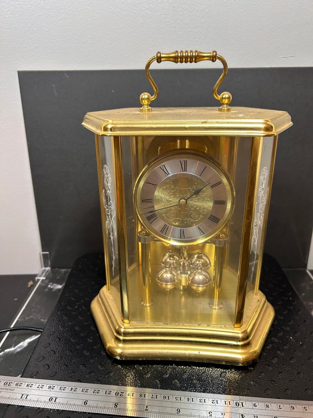vintage German mantle clock with gold hexagonal glass case and etched roses.